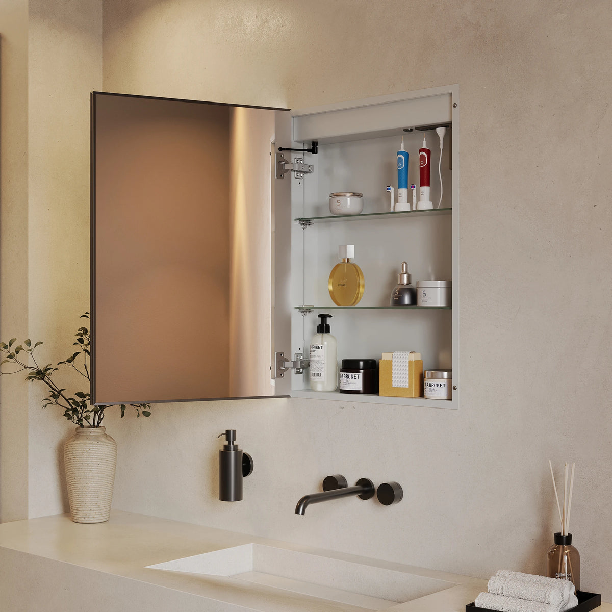 A wall-mounted medicine cabinet with an open door, showing three glass shelves stocked with toiletries, installed above a sink in a modern bathroom with textured beige walls. #Size_500mm x 700mm