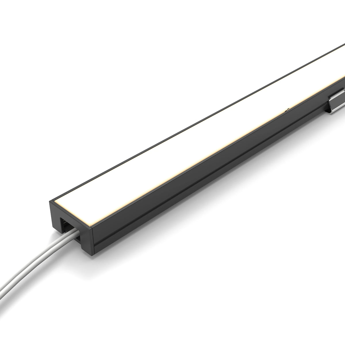 A modern linear LED light fixture with a matte black housing and a white diffuser panel, shown at an angle with a gray power cable extending from the side against a white background. #Finish_Black